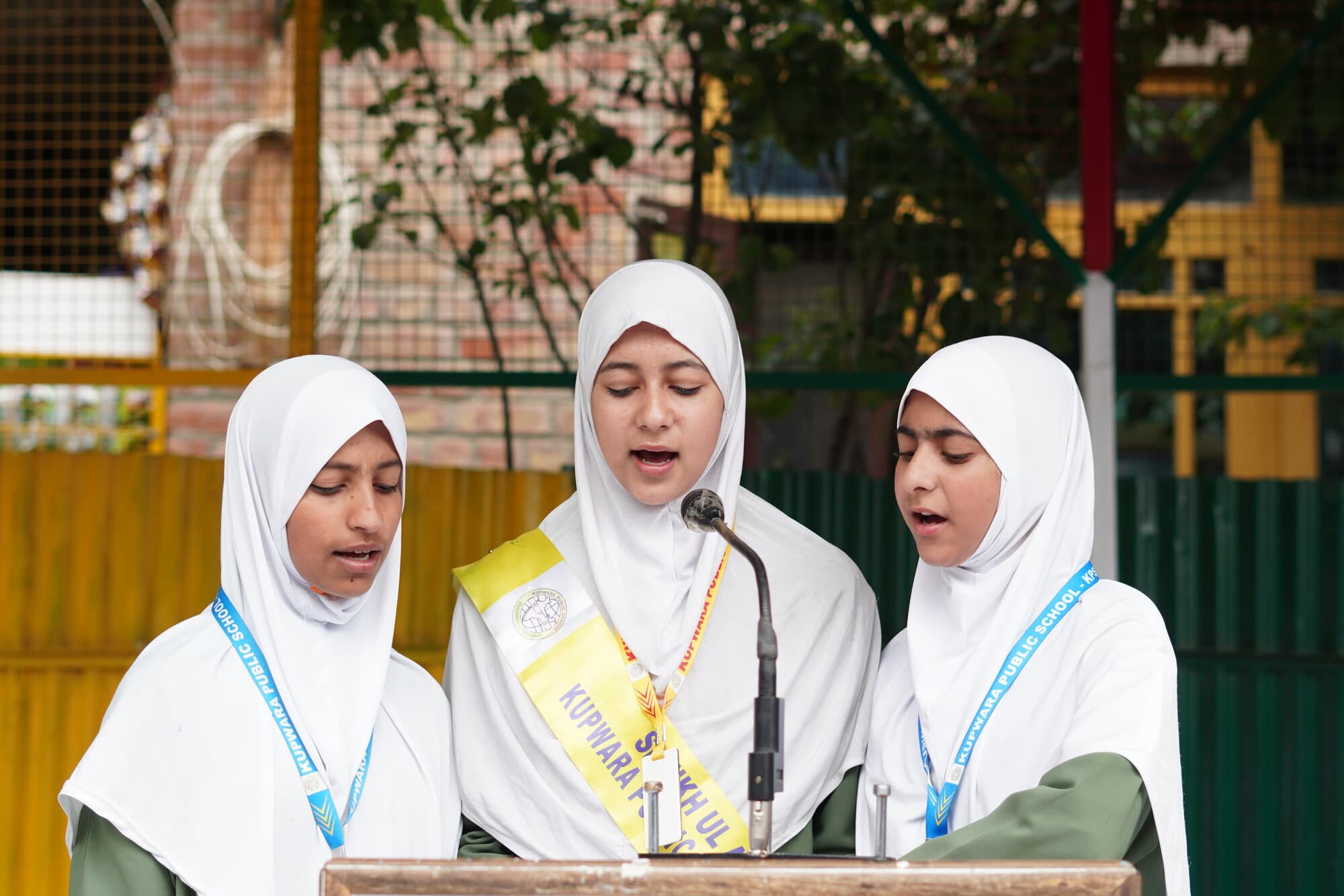 Students speaking at the podium during an inter-school event