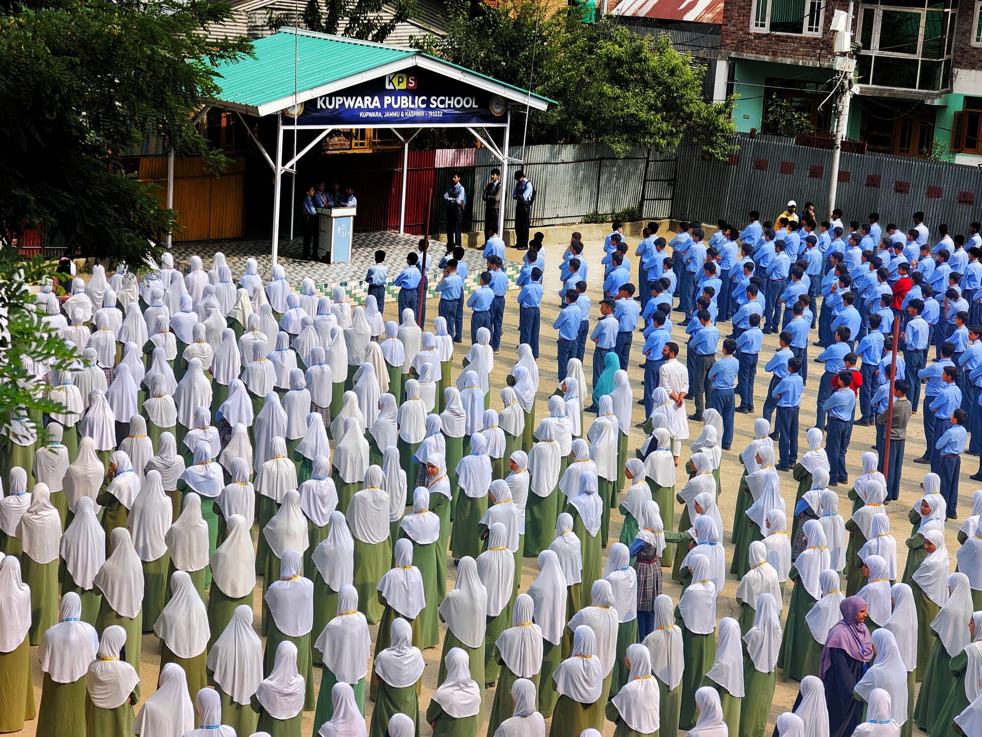 Large school assembly beneath the Kupwara Public School banner