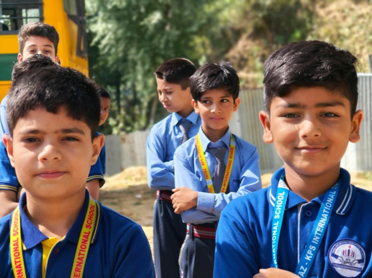 Fayaz-KPS students waiting beside the school bus