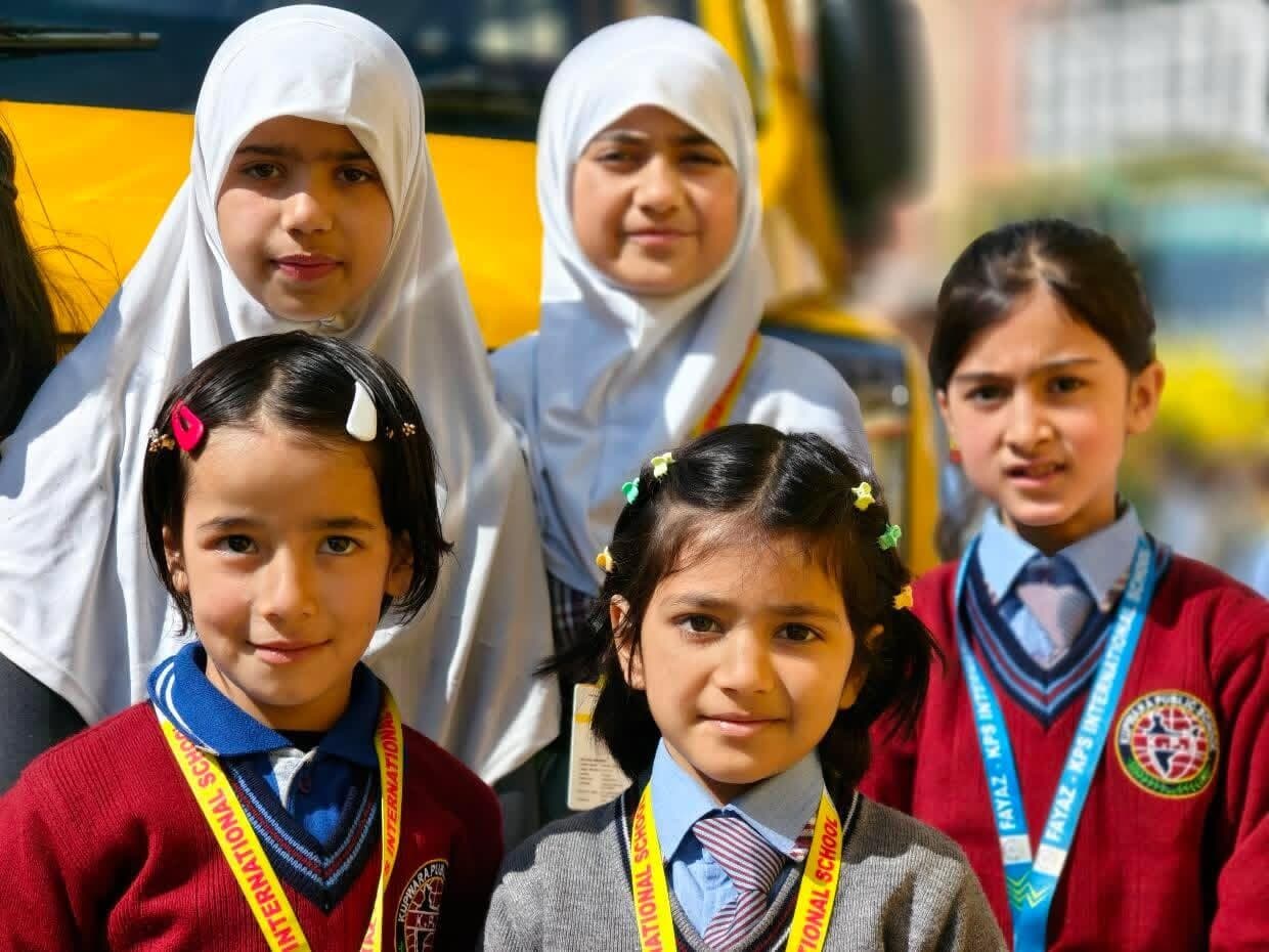 Fayaz-KPS students together beside the school bus