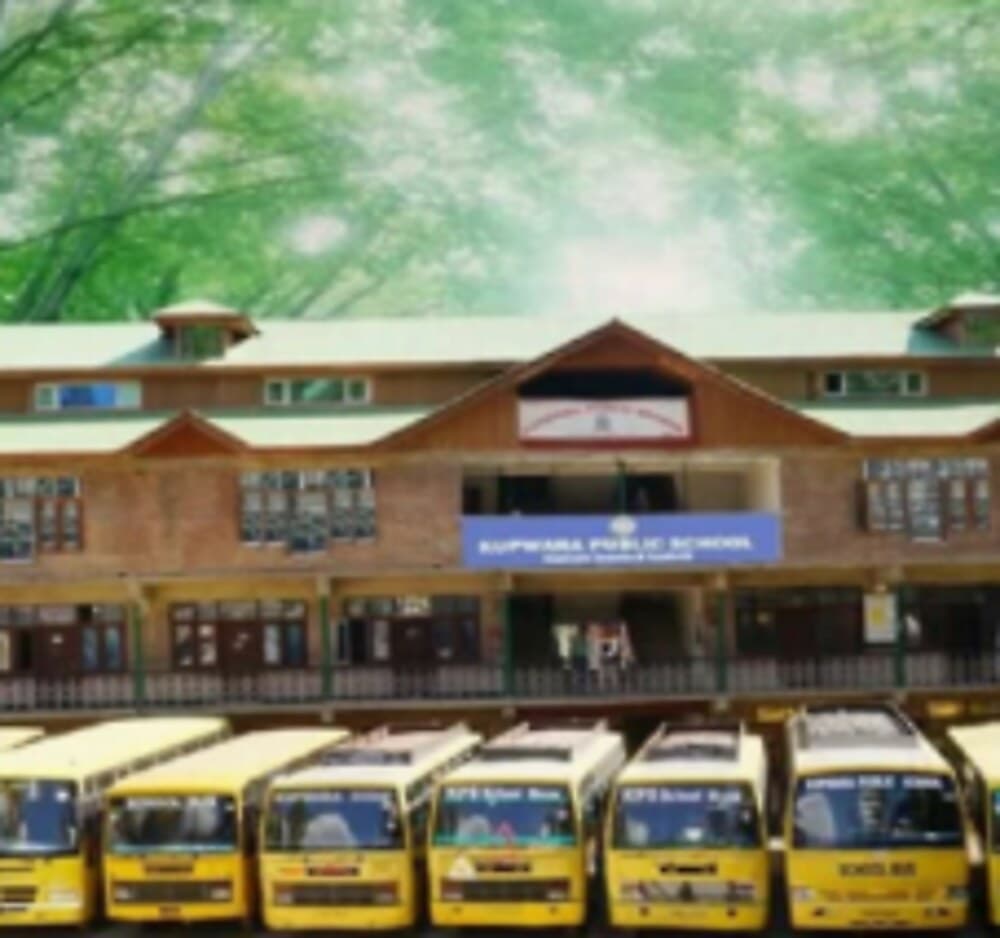Kupwara Public School building with the school bus fleet