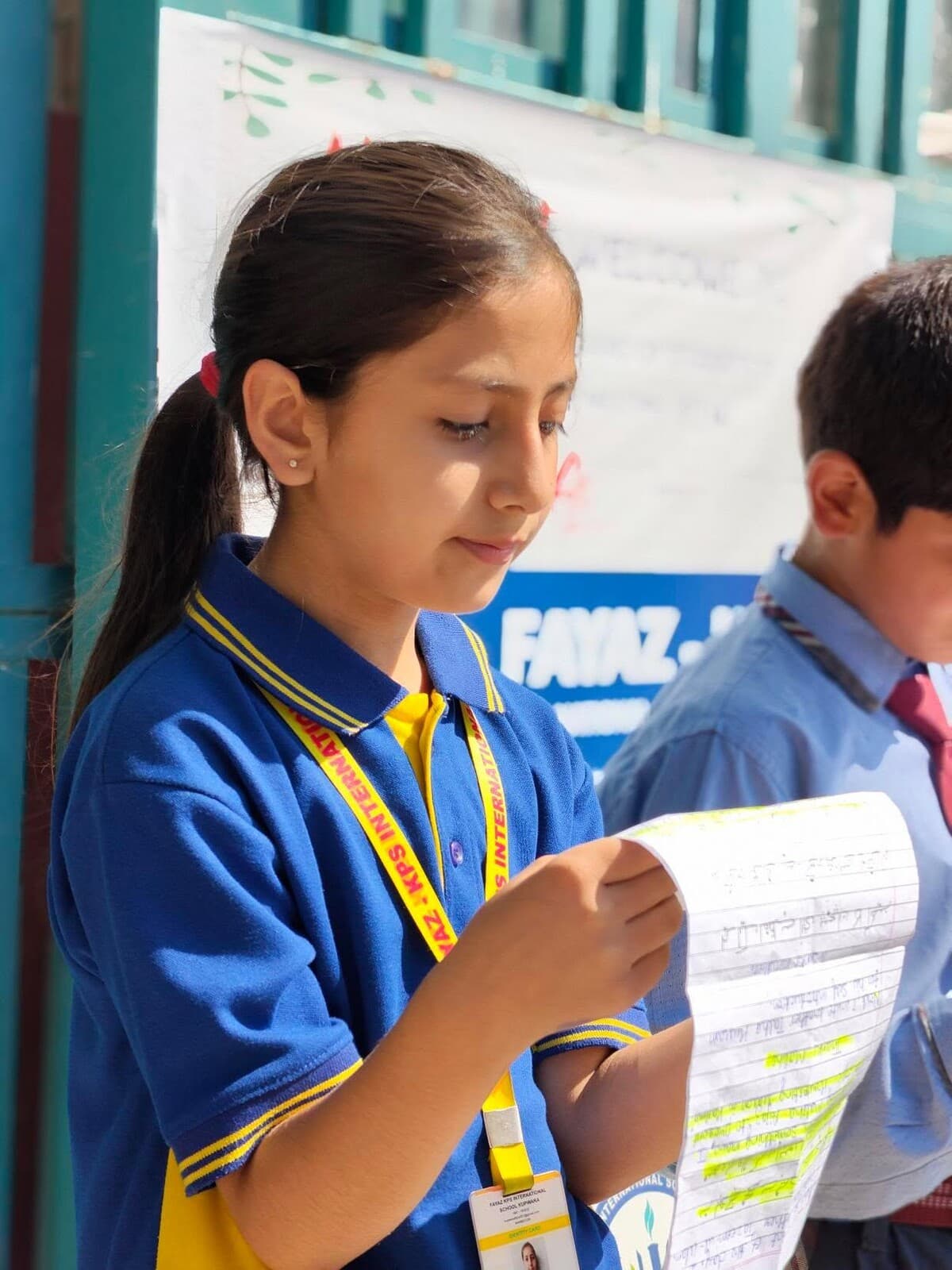 A Fayaz-KPS student reading her notes outside class